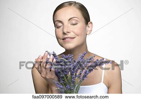 Stock Photo - Young woman with lavender bouquet. Fotosearch
