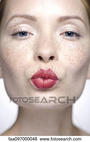 Young woman with pursed lips wearing red lipstick, close-up View Large Photo Image Stock Photo - Young woman with pursed lips wearing red lipstick, close-up. Fotosearch