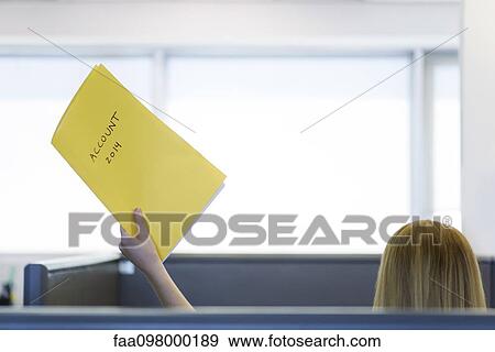 Stock Photo - Accountant in office handing file folder to out-of-frame associate. Fotosearch
