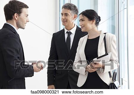 Business associates chatting View Large Photo Image Stock Image - Business associates chatting. Fotosearch