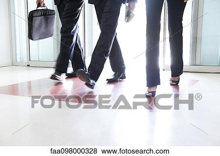 Business associates entering building together View Large Photo Image Stock Photo - Business associates entering building together. Fotosearch