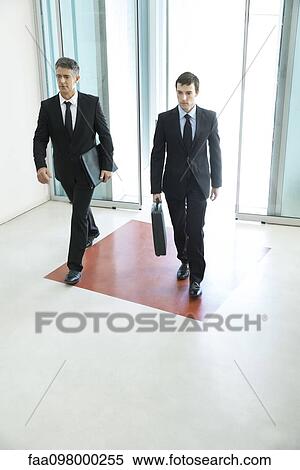Business associates entering building together View Large Photo Image Stock Photography - Business associates entering building together. Fotosearch