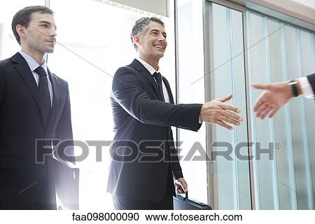 Business associates shaking hands View Large Photo Image Stock Image - Business associates shaking hands. Fotosearch