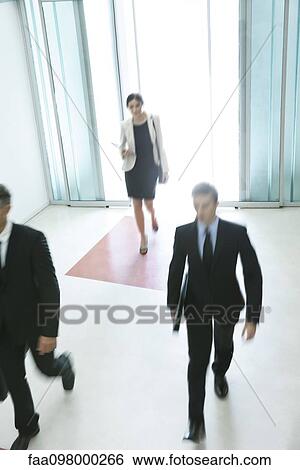 Stock Photograph - Business professionals arriving for another day of work. Fotosearch