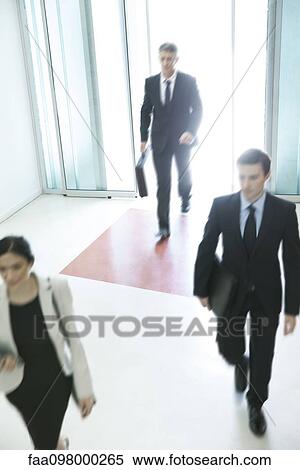 Stock Photography - Business professionals arriving for another day of work. Fotosearch