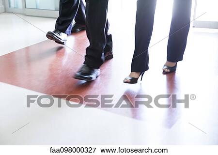 Business professionals entering building View Large Photo Image Stock Photo - Business professionals entering building. Fotosearch