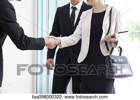 Businesswoman being introduced to business associate View Large Photo Image Stock Image - Businesswoman being introduced to business associate. Fotosearch