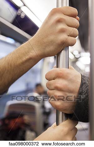 Communters on subway holding grab handle, close-up View Large Photo Image Stock Image - Communters on subway holding grab handle, close-up. Fotosearch