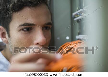 Computer technician performing maintenance work on networking equipment View Large Photo Image Stock Image - Computer technician performing maintenance work on networking equipment. Fotosearch