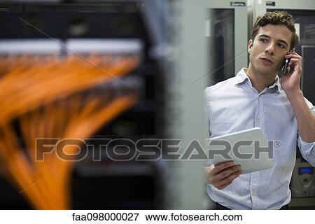 Computer technician performing maintenance check of mainframe equipment View Large Photo Image Stock Photo - Computer technician performing maintenance check of mainframe equipment. Fotosearch