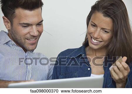 Couple shopping online with credit card View Large Photo Image Stock Image - Couple shopping online with credit card. Fotosearch