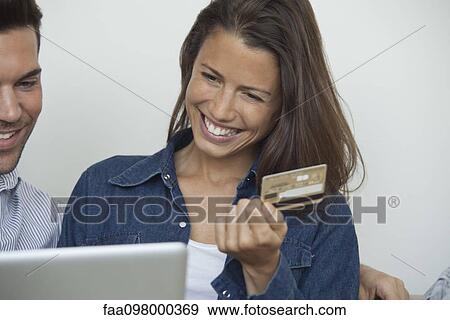 Stock Photo - Couple shopping online with credit card. Fotosearch