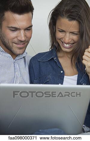 Couple using laptop computer together View Large Photo Image Stock Image - Couple using laptop computer together. Fotosearch