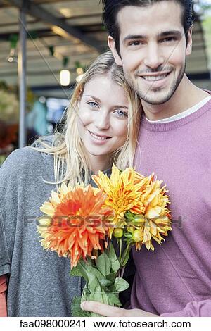 Couple with flower bouquet, portrait View Large Photo Image Stock Image - Couple with flower bouquet, portrait. Fotosearch