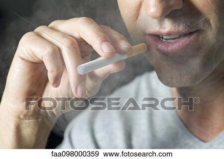 Man smoking electonic cigarette, cropped View Large Photo Image Stock Photo - Man smoking electonic cigarette, cropped. Fotosearch