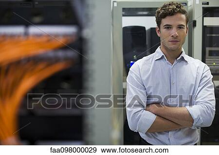 Network cables connected to computer mainframe, computer technician in background View Large Photo Image Stock Photo - Network cables connected to computer mainframe, computer technician in background. Fotosearch