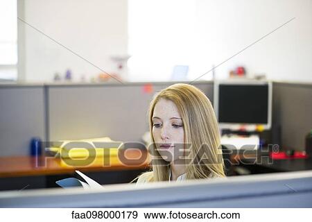 Stock Photo - Office worker in office cubicle. Fotosearch