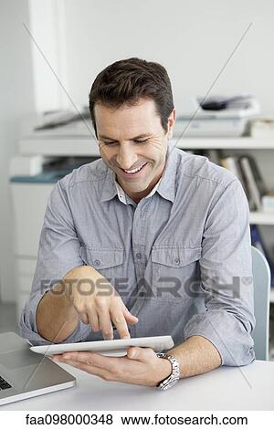 Office worker using digital tablet View Large Photo Image Stock Photo - Office worker using digital tablet. Fotosearch