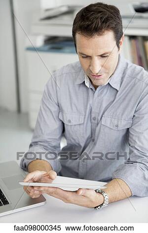 Stock Photography - Office worker using digital tablet. Fotosearch