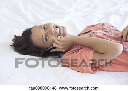 Phone calls bridge the distance between separated friends, family and loved ones View Large Photo Image Stock Photo - Phone calls bridge the distance between separated friends, family and loved ones. Fotosearch