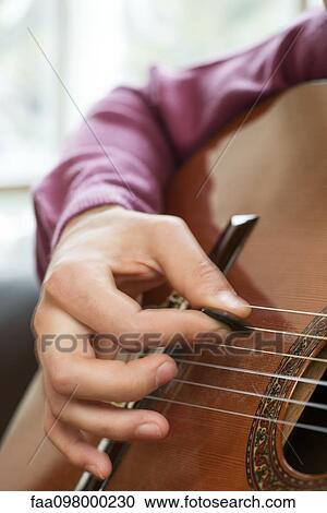 Stock Image - Playing acoustic guitar. Fotosearch