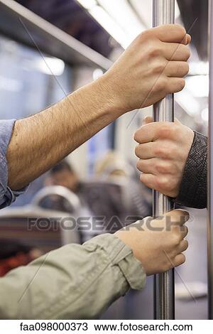 Subway commuters holding onto grab handle View Large Photo Image Stock Image - Subway commuters holding onto grab handle. Fotosearch