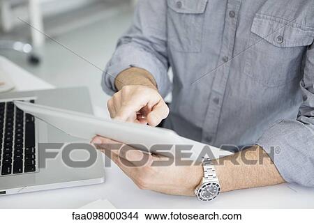 Using digital tablet with touch screen View Large Photo Image Picture - Using digital tablet with touch screen. Fotosearch