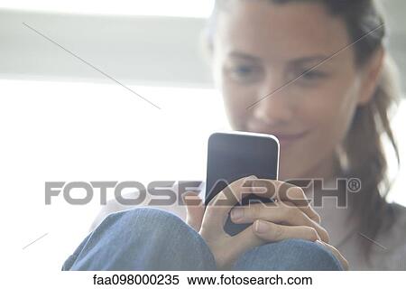 Woman browsing web with smatrphone View Large Photo Image Stock Photography - Woman browsing web with smatrphone. Fotosearch