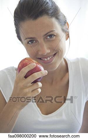 Woman holding apple, portrait View Large Photo Image Stock Image - Woman holding apple, portrait. Fotosearch