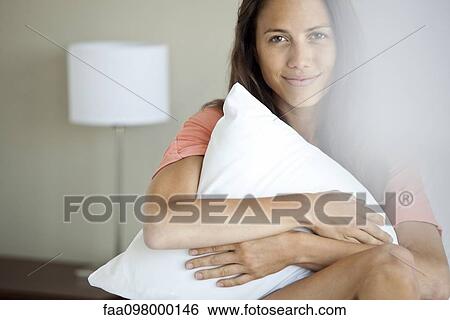 Woman hugging pillow to self, portrait View Large Photo Image Stock Photograph - Woman hugging pillow to self, portrait. Fotosearch