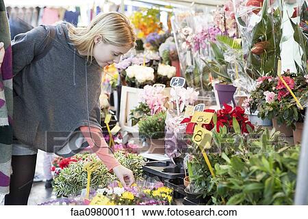 Woman in flower shop browsing bouquet selection View Large Photo Image Stock Image - Woman in flower shop browsing bouquet selection. Fotosearch