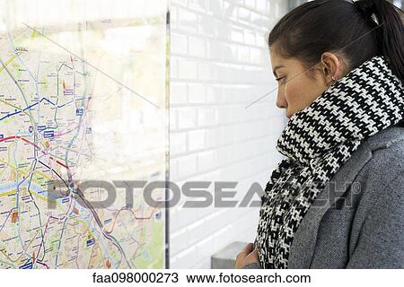 Woman looking at public transit map View Large Photo Image Stock Image - Woman looking at public transit map. Fotosearch