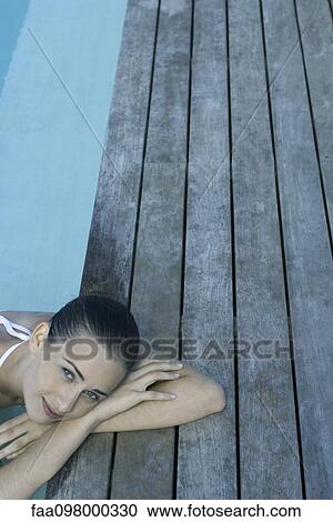 Woman relaxing in pool, high angle view View Large Photo Image Stock Image - Woman relaxing in pool, high angle view. Fotosearch