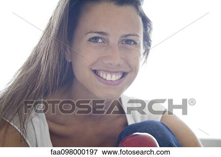Stock Photo - Woman smiling cheerfully, portrait. Fotosearch