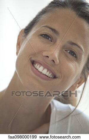 Stock Photo - Woman smiling cheerfully, portrait. Fotosearch