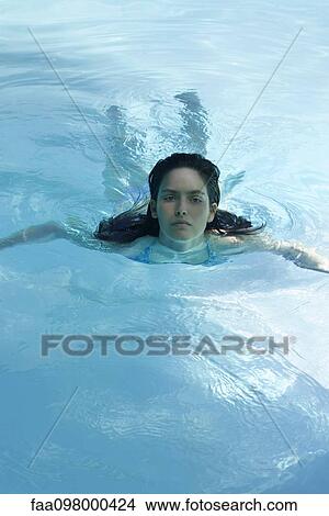 Picture - Woman swimming in pool. Fotosearch