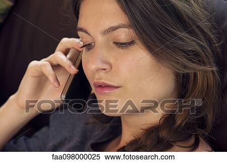 Stock Photography - Woman talking on cell phone. Fotosearch