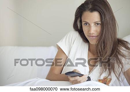 Woman watching TV in bed View Large Photo Image Stock Image - Woman watching TV in bed. Fotosearch