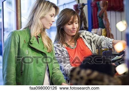 Stock Photograph - Women clothes shopping together. Fotosearch