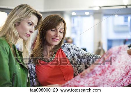 Women dress shopping together View Large Photo Image Stock Photo - Women dress shopping together. Fotosearch