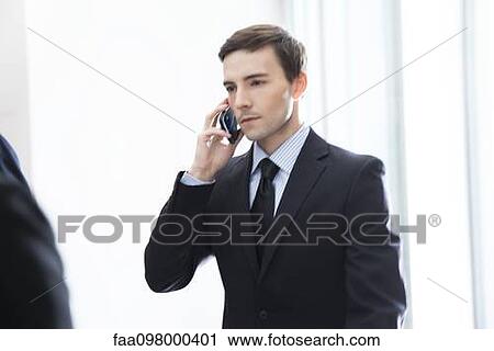 Stock Image - Young businessman on the move. Fotosearch