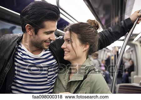Young couple riding subway together View Large Photo Image Stock Photo - Young couple riding subway together. Fotosearch
