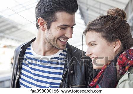 Stock Photograph - Young couple together on train platform. Fotosearch