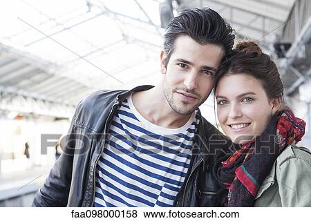 Young couple together on train platform, portrait View Large Photo Image Stock Photo - Young couple together on train platform, portrait. Fotosearch