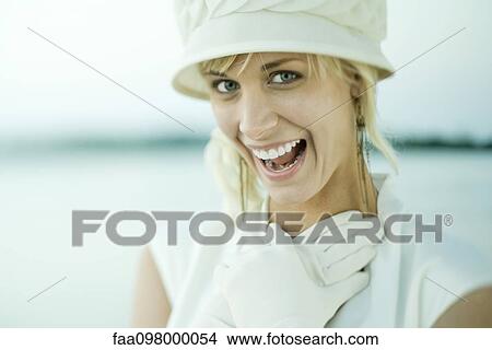 Young woman laughing, gloved hands clasped on chest View Large Photo Image Picture - Young woman laughing, gloved hands clasped on chest. Fotosearch