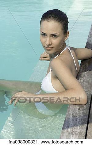 Young woman sitting in swimming pool View Large Photo Image Stock Image - Young woman sitting in swimming pool. Fotosearch