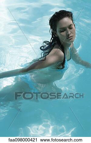 Young woman swimming in swimming pool View Large Photo Image Stock Image - Young woman swimming in swimming pool. Fotosearch