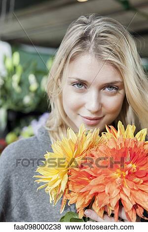 Young woman with flower bouquet, portrait View Large Photo Image Stock Photo - Young woman with flower bouquet, portrait. Fotosearch