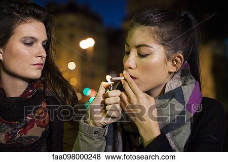 Young women smoking marijuana together View Large Photo Image Stock Photo - Young women smoking marijuana together. Fotosearch