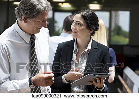 Business professionals marvelling at features of new digital tablet View Large Photo Image Stock Image - Business professionals marvelling at features of new digital tablet. Fotosearch